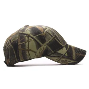 Side view detail of camouflage baseball cap with realistic wood and leaf pattern design.