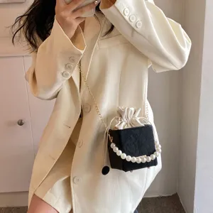 Stylish women bucket bag with pearl handle and chain strap, perfect for summer casual daily use.