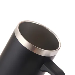 Close-up detail of stainless steel insulated mug featuring brushed metal rim and black handle.