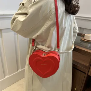 Trendy red heart-shaped crossbody bag for women, chic single shoulder bag with sleek design.
