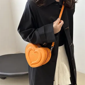 Orange heart-shaped crossbody bag for women, trendy niche design single shoulder bag.