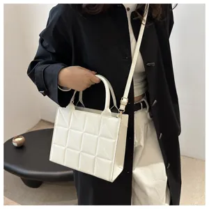 Chic white quilted crossbody bag for women, stylish geometric handbag with shoulder strap.