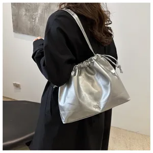 Silver metallic shoulder bucket bag with drawstring closure and chic bow detail for women.