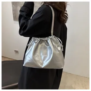 Silver metallic drawstring shoulder bag detail, soft leather bucket tote with cute bow accent.