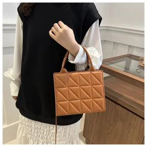 Detailed shot of brown quilted handbag showing premium leather texture and stitching craft.