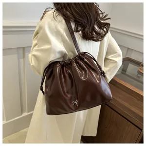 Stylish soft leather shoulder bag for women, commuter crossbody bucket bag with drawstring.