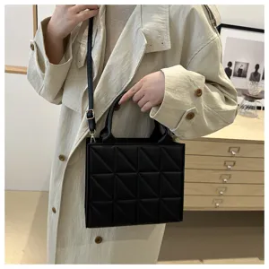 Stylish black quilted handbag for women, versatile top-handle shoulder and crossbody bag.