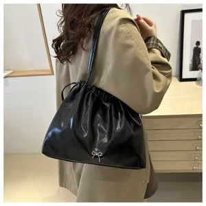 Stylish black soft leather shoulder bucket bag for women, chic commuting crossbody bag.