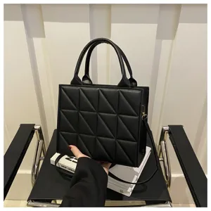Black quilted structured handbag for women, stylish top handle shoulder crossbody bag with geometric design.