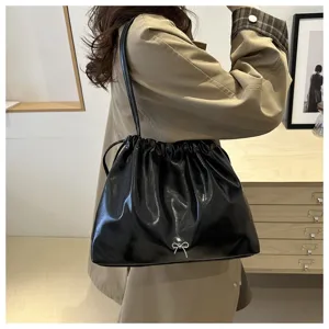 Elegant black soft leather shoulder bag detail, stylish drawstring design for daily commute.