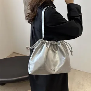 Stylish metallic silver shoulder bucket bag for women, soft leather casual handbag with drawstring.