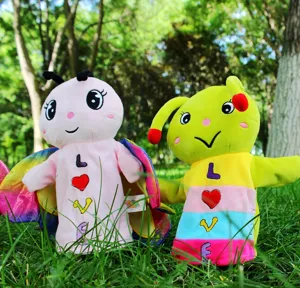 Detail view of cute cartoon butterfly and caterpillar plush hand puppets, soft toy interaction.