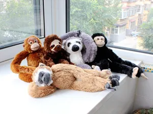 Detail view of cute hanging plush long-arm toys, including lemur, sloth and monkey dolls.