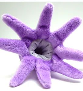 Close-up detail of purple plush octopus finger puppet showing soft tentacle design and inner mesh fabric.