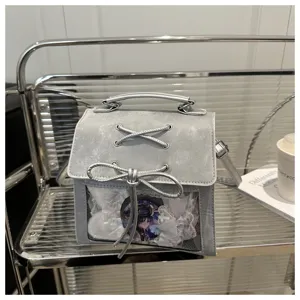 Détail de sac ita en cuir synthétique gris, fenêtre transparente avec ruban dentelle et badge