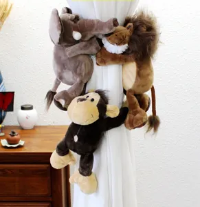Close-up detail of cute cartoon animal plush curtain tiebacks in use on a white curtain.
