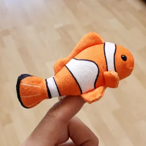 Clownfish plush finger puppet detail shot, cute ocean animal toy for interactive play kids.