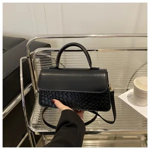 Retro black crossbody bag with woven embossed texture, stylish top handle shoulder bag.