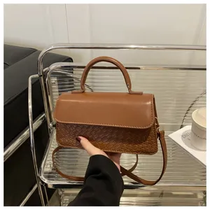 Classic brown woven top handle crossbody bag for women, stylish vintage shoulder handbag.
