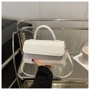 White faux leather crossbody bag with woven texture, top handle and adjustable shoulder strap.