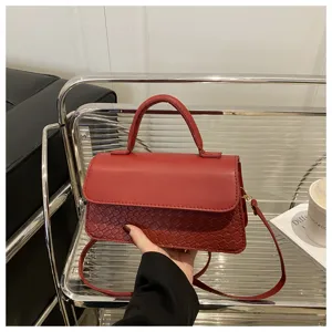 Red PU leather handbag and crossbody bag with woven texture flap design for women.