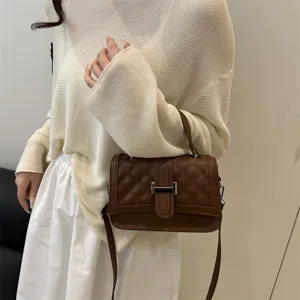 Chic brown quilted shoulder bag for women, elegant crossbody purse with metal lock design.