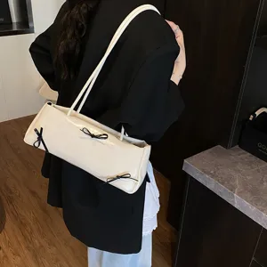 Chic minimalist underarm shoulder bag with cute black bow ties, trendy beige casual purse.