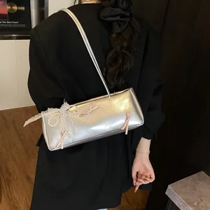 Women silver underarm shoulder bag with cute lace pearl bows, stylish summer fashion.