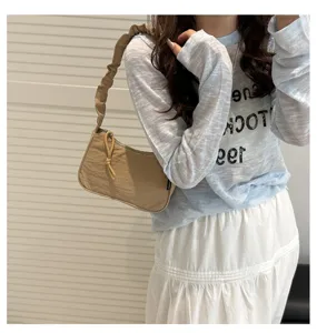 Detailed view of the casual pleated drawstring shoulder bag, stylish commuter handbag.