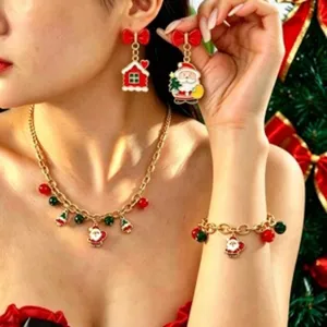 Detailed view of Christmas jewelry set featuring Santa charms, necklace, bracelet and earrings.