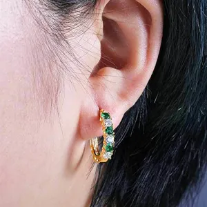 Exquisite U-shaped hoop earrings featuring green and white zirconia, stylish fashion jewelry details.