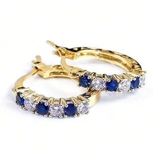 Gold-plated U-shaped hoop earrings featuring sparkling blue and white cubic zirconia stones.