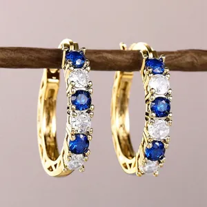 Gold plated French style hoop earrings with blue and white zircon stones detail view
