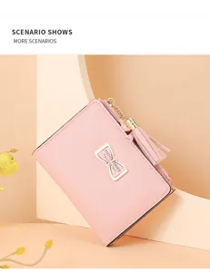 Pink short women's wallet with metal bow and tassel detail, stylish compact coin purse.