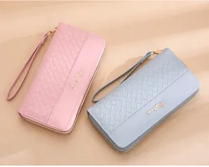 Detailed view of women's woven long wallet with zip-around closure and convenient wrist strap.