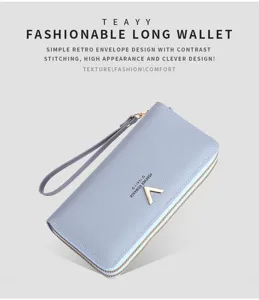 Detailed view of women long zipper wallet in light blue PU leather with wristlet strap.