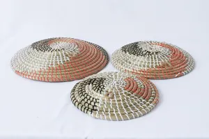 Dettaglio piatto decorativo da parete intrecciato a spirale tricor per arredamento moderno.