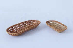 Woven rattan storage tray detail showing delicate hollow design, natural wicker texture for decor.