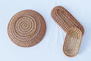 Detailed view of handmade woven rattan hollow tray and snack dish, natural material.