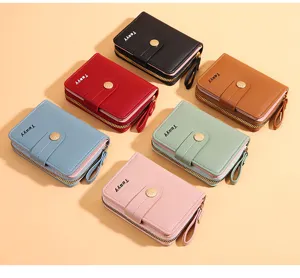 Close-up detail of multi-color short zipper wallets with button closure and card slots.