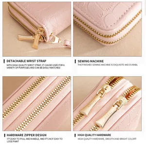 Pink double zipper long wallet detail view, featuring durable hardware and wrist strap.