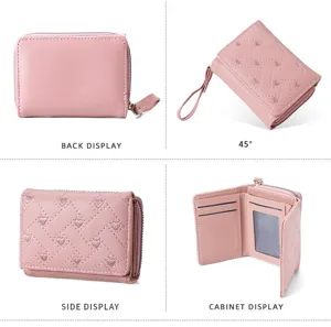 Detailed view of women pink short wallet, heart quilted pattern, multiple card slots and zipper.