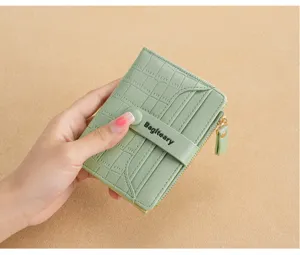 Close-up view of a light green bifold wallet featuring multiple card slots and secure zipper.