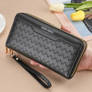 Black long women wallet with wristlet zipper closure and chic chevron pattern design.