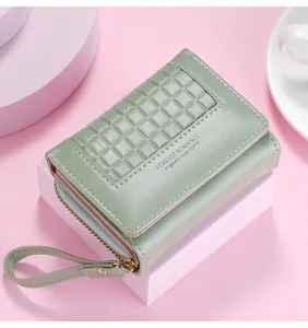 Detailed view of the stylish light green short women wallet with grid texture and wrist strap.