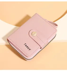 Pink short wallet detail view, featuring secure zipper closure and snap button design.