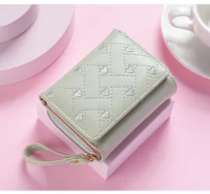 Detail view of women short trifold wallet featuring cute embroidered heart pattern and wrist strap.