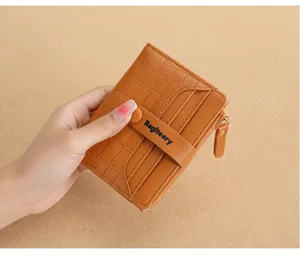 Detail view of brown crocodile pattern short wallet, multi-card slots and coin pocket.