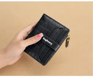 Bifold women's short wallet with multiple card slots, zipper coin pocket and stylish strap closure.