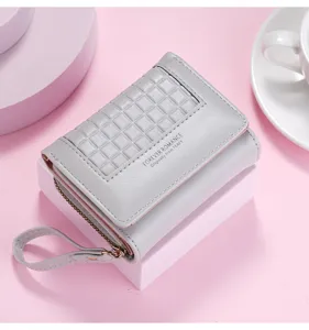 Grey short tri-fold wallet detail view with grid embossed pattern, zipper coin pocket, and wrist strap.